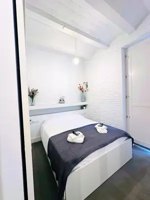 a white room with a bed with towels on it at Splendid houses in Valencia in Valencia