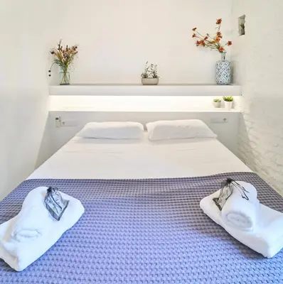 a bedroom with a bed with towels on it at Splendid houses in Valencia in Valencia