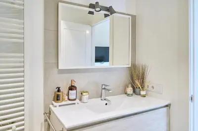 a bathroom with a white sink and a mirror at Splendid houses in Valencia in Valencia