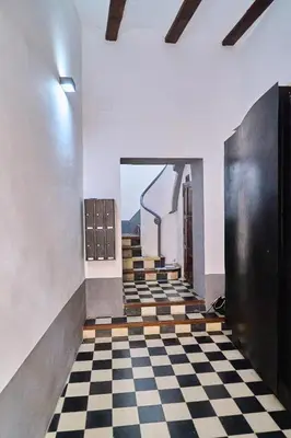 a hallway with a checkered floor and stairs at Splendid houses in Valencia in Valencia
