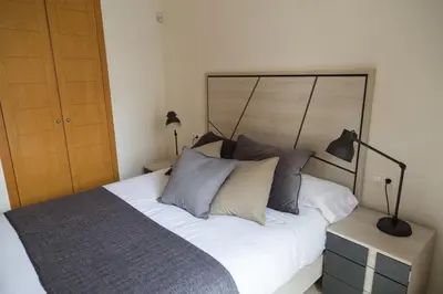 a living room with a blue couch and a table at New Aloha Apartment Center with terrace Valencia in Valencia