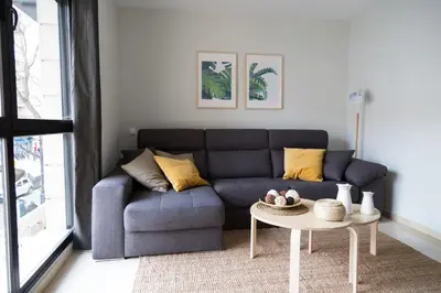 a living room with a table and white chairs at New Aloha Apartment Center with terrace Valencia in Valencia