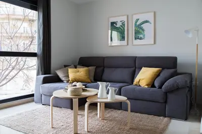 a bed with a yellow pillow on it in a bedroom at New Aloha Apartment Center with terrace Valencia in Valencia