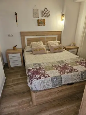 a bedroom with a bed and two night stands at 