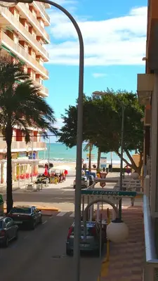 a street light with a view of a beach at 