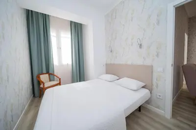a bedroom with a bed with a book on it at Una Ubicacion Perfecta in Valencia