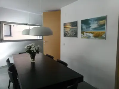 a dining room table with a vase of flowers on it at Apartamento Forn dels Apòstols in Valencia