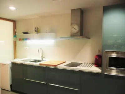 a kitchen with a sink and a clock on the wall at Apartamento Forn dels Apòstols in Valencia