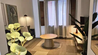 a living room with a table and a couch at Apartamentos Carmen del Turia in Valencia