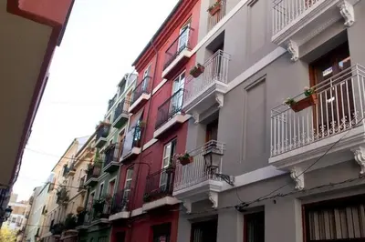a row of buildings with balconies and plants on them at Apartamentos Carmen del Turia in Valencia