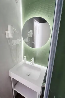 a bathroom with a white sink and a mirror at Apartamentos Carmen del Turia in Valencia