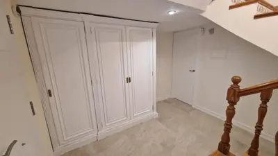 a room with white cabinets and a staircase at Beachfront vila in Valencia