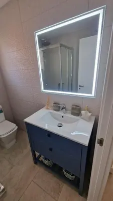 a bathroom with a sink with a mirror and a toilet at Beachfront vila in Valencia