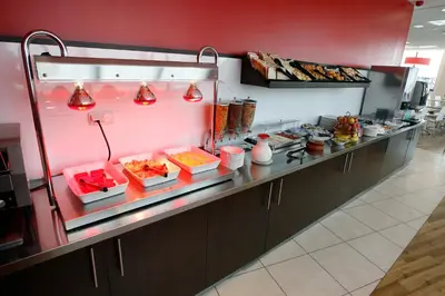 a buffet line with food in a restaurant at Travelodge Valencia Aeropuerto in Manises