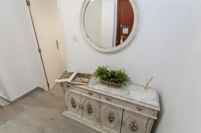 a mirror on top of a dresser in a hallway at VLC - Cisneros in Valencia