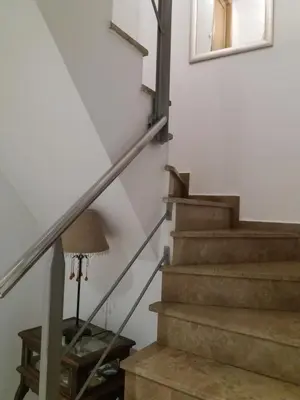a staircase in a house with a lamp and a mirror at Atico Duplex Luminoso in Valencia