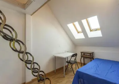 a bedroom with a bed and a table and skylights at Atico Duplex Luminoso in Valencia