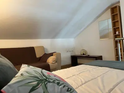a living room with a bed and a couch at Atico Duplex Luminoso in Valencia
