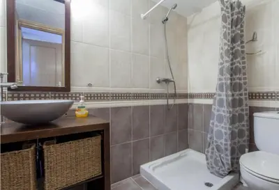 a bathroom with a sink and a toilet and a shower at Atico Duplex Luminoso in Valencia
