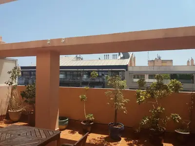 a balcony with potted plants and a view of a building at Atico Duplex Luminoso in Valencia