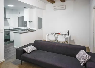 a living room with a couch and a kitchen at Ambrosio Flats Valencia - El Mercat in Valencia