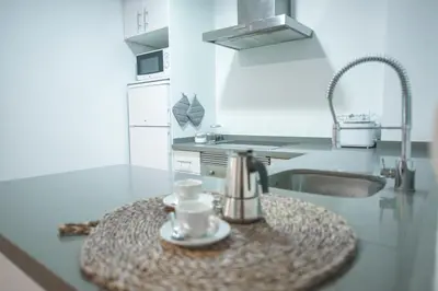 a kitchen with a sink and a coffee cup on a counter at Ambrosio Flats Valencia - El Mercat in Valencia
