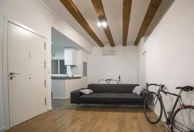 a living room with a couch and a bike at Ambrosio Flats Valencia - El Mercat in Valencia