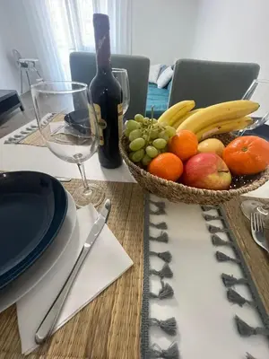 a table with a bowl of fruit and a bottle of wine at Sweet Home in Valencia
