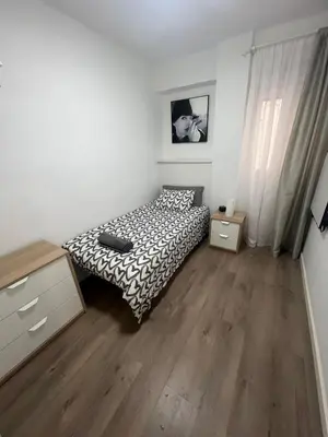 a bedroom with a bed and a dresser at Sweet Home in Valencia