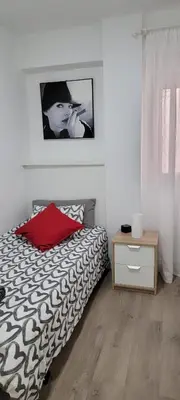 a bedroom with a bed and a picture on the wall at Sweet Home in Valencia
