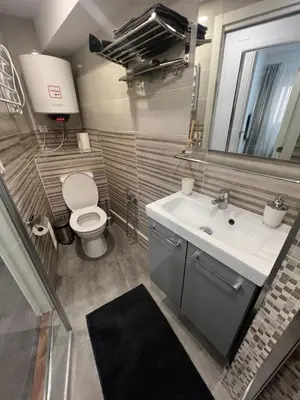 a bathroom with a sink and a toilet and a mirror at Sweet Home in Valencia