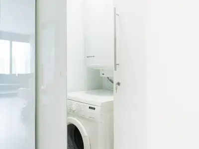 a white washer and dryer in a white room at Flat El Porto - Valencia in Valencia