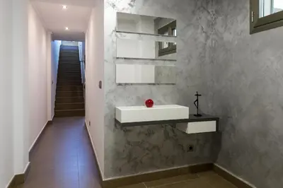 a bathroom with a white sink and a staircase at ApartUP Patacona Terrace Duplex I in Valencia