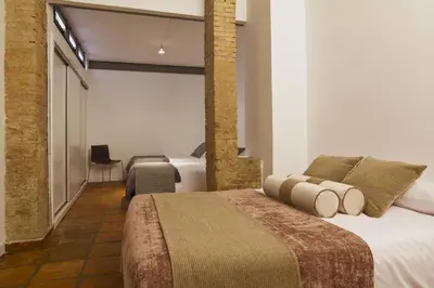 a hotel room with two beds and a window at Apartamentos La Xerea in Valencia
