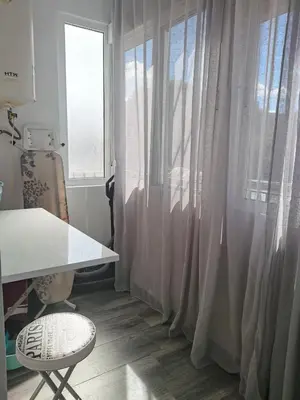 a room with white curtains and a desk and a chair at Plaza Sainetero in Valencia