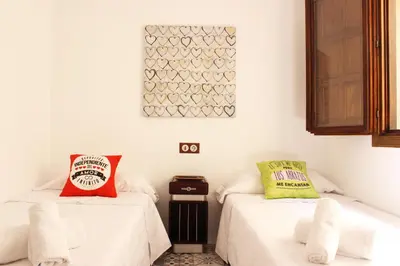 two beds in a room with white walls at Casa Los gorgos in Anna