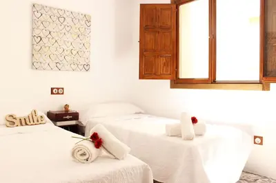 a room with two beds with towels on them at Casa Los gorgos in Anna