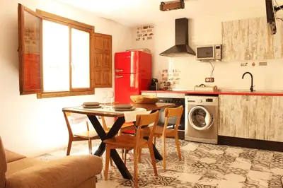 a kitchen with a table and a red refrigerator at Casa Los gorgos in Anna