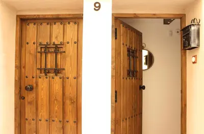 a wooden door in a room with a hallway at Casa Los gorgos in Anna