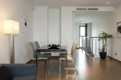 a dining room with a glass table and chairs at ApartUP Patacona Terrace Duplex II in Valencia