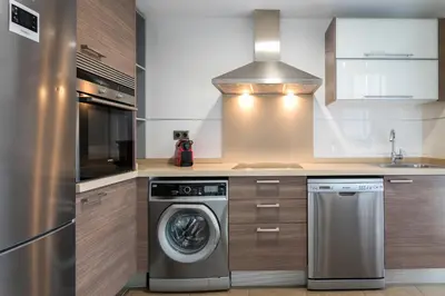 a kitchen with a washing machine and a sink at ApartUP Patacona Terrace Duplex II in Valencia