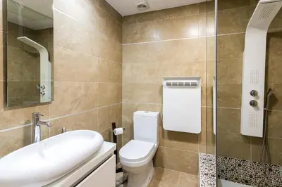 a bathroom with a toilet and a sink and a shower at ApartUP Patacona Terrace Duplex II in Valencia