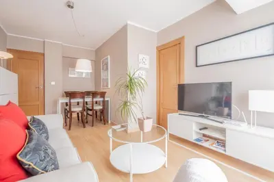 a living room with a couch and a tv at 1ªLinea de playa Puerto de Sagunto in Puerto de Sagunto
