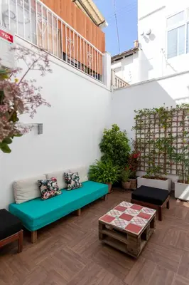 a patio with a couch and a table at Family ARTpartment in Valencia
