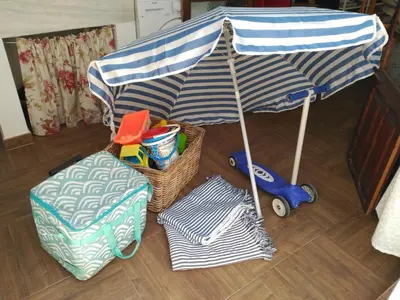 a blue and white umbrella and some baskets and a toy car at Family ARTpartment in Valencia