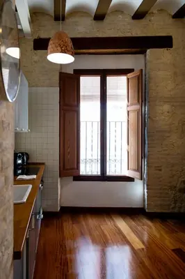 a kitchen with a large window and wooden floors at Botanico Silence in Valencia