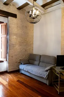 a living room with a couch and a chandelier at Botanico Silence in Valencia