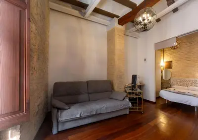 a living room with a couch and a bed at Botanico Silence in Valencia