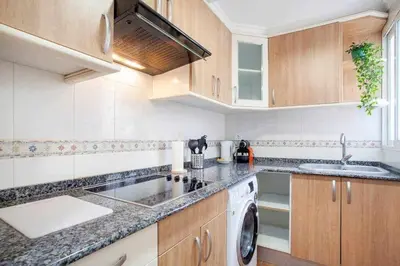 a kitchen with a sink and a washing machine at Reus, Lovely Flat Close to Center in Valencia