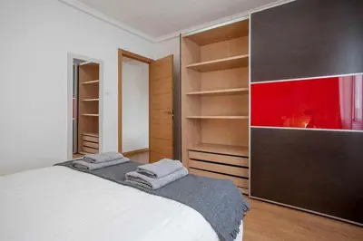 a bedroom with a bed and a large closet at Reus, Lovely Flat Close to Center in Valencia